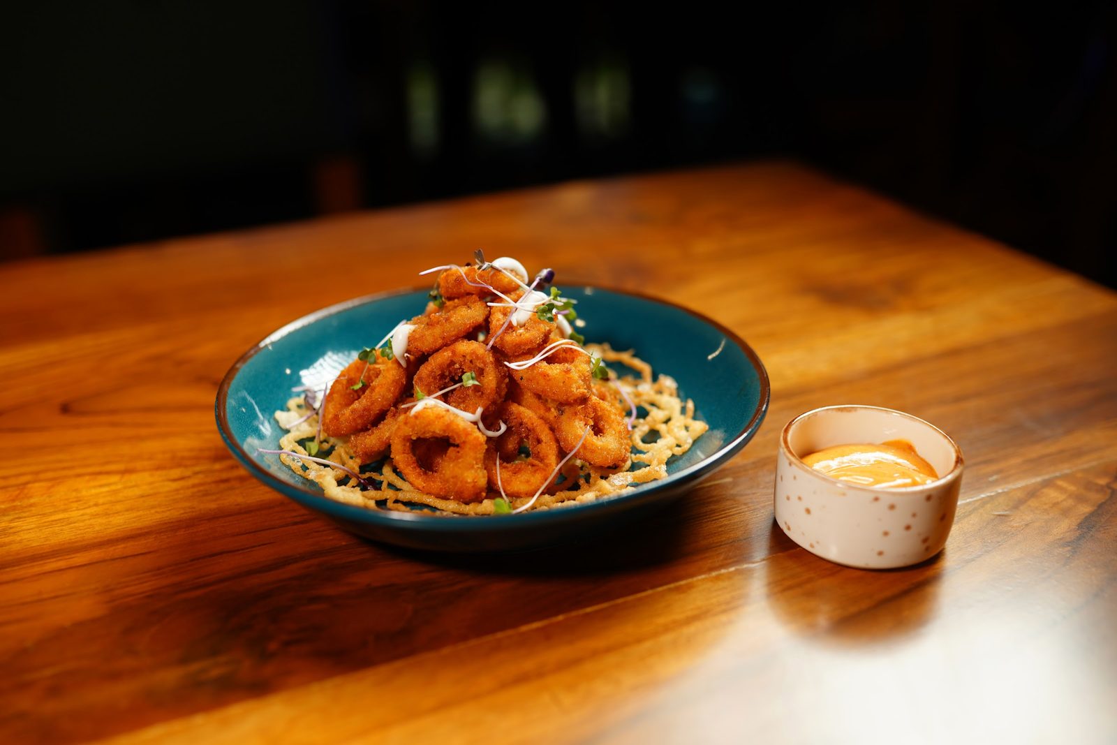 Golden fried calamari rings with a dip