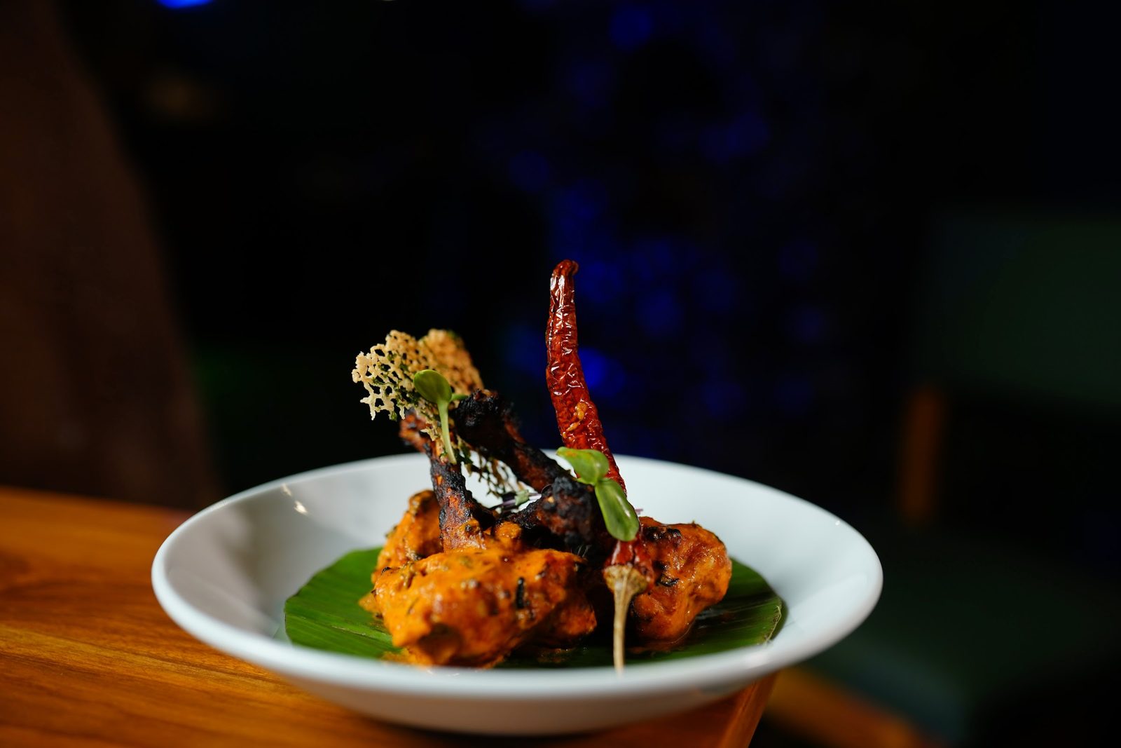 Tandoor-fired kebabs in a clay pot with dried red chilli