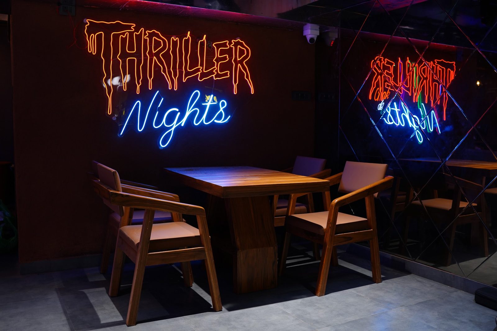 Neon signs, mirrored walls and wooden tables in the lounge