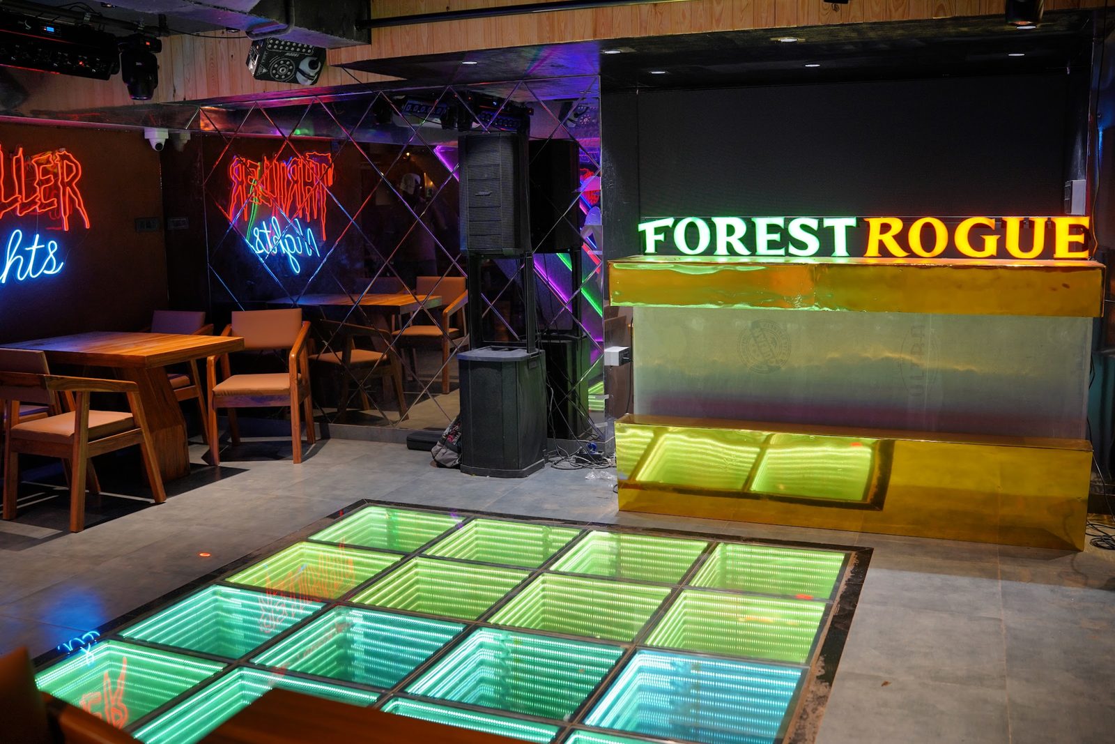 Glowing infinity-tile dance floor under the Forest Rogue sign